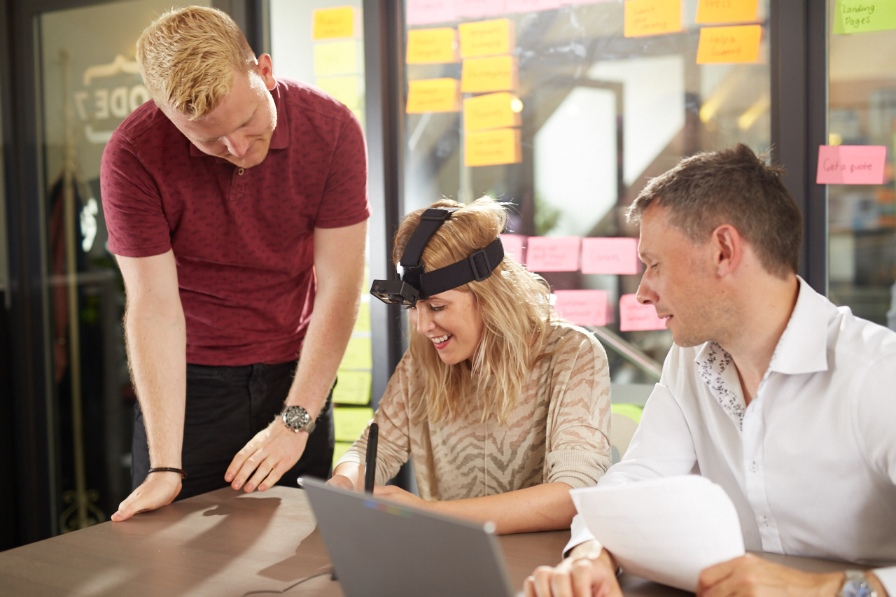 People carrying out usability testing on a site with a mobile device